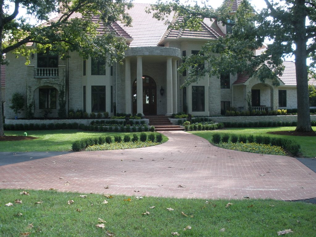 A formal brick arrival court and clipped hedges