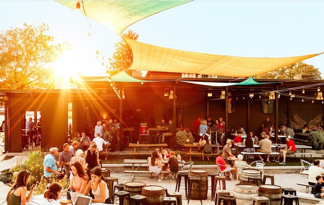 A lively outdoor gathering space at sunset