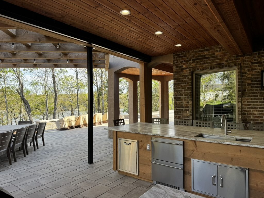 An outdoor kitchen island looking out to the woods