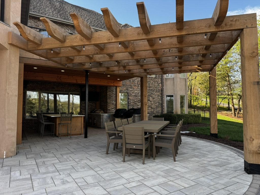A cedar pergola over a paver dining terrace