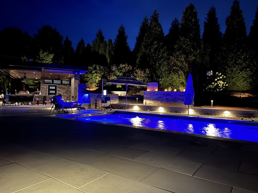 A pool and stone walls lit at dusk